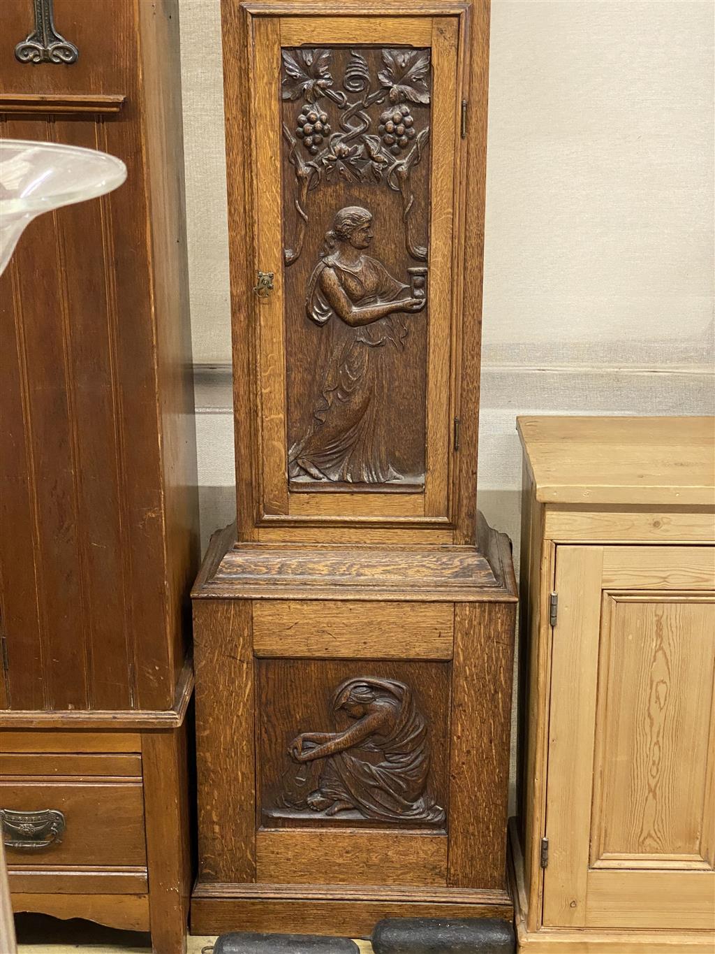 A 1914 carved oak eight day longcase clock, height 230cm